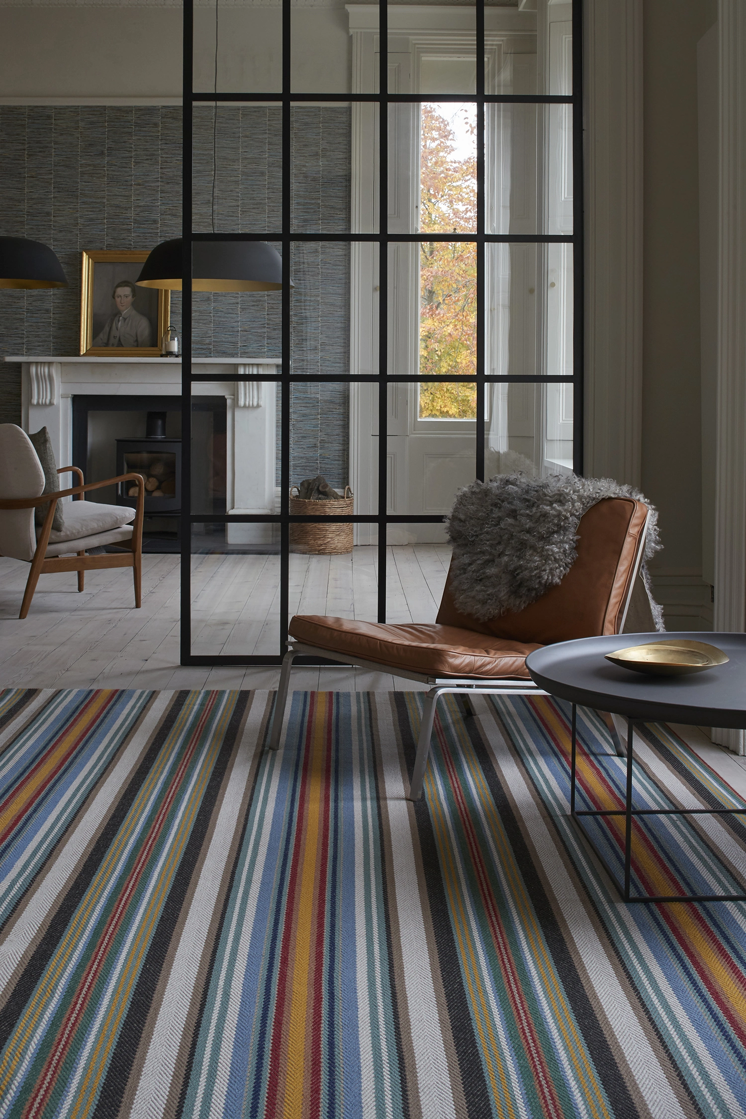 A multi-coloured large rug in a modern open plan living room.