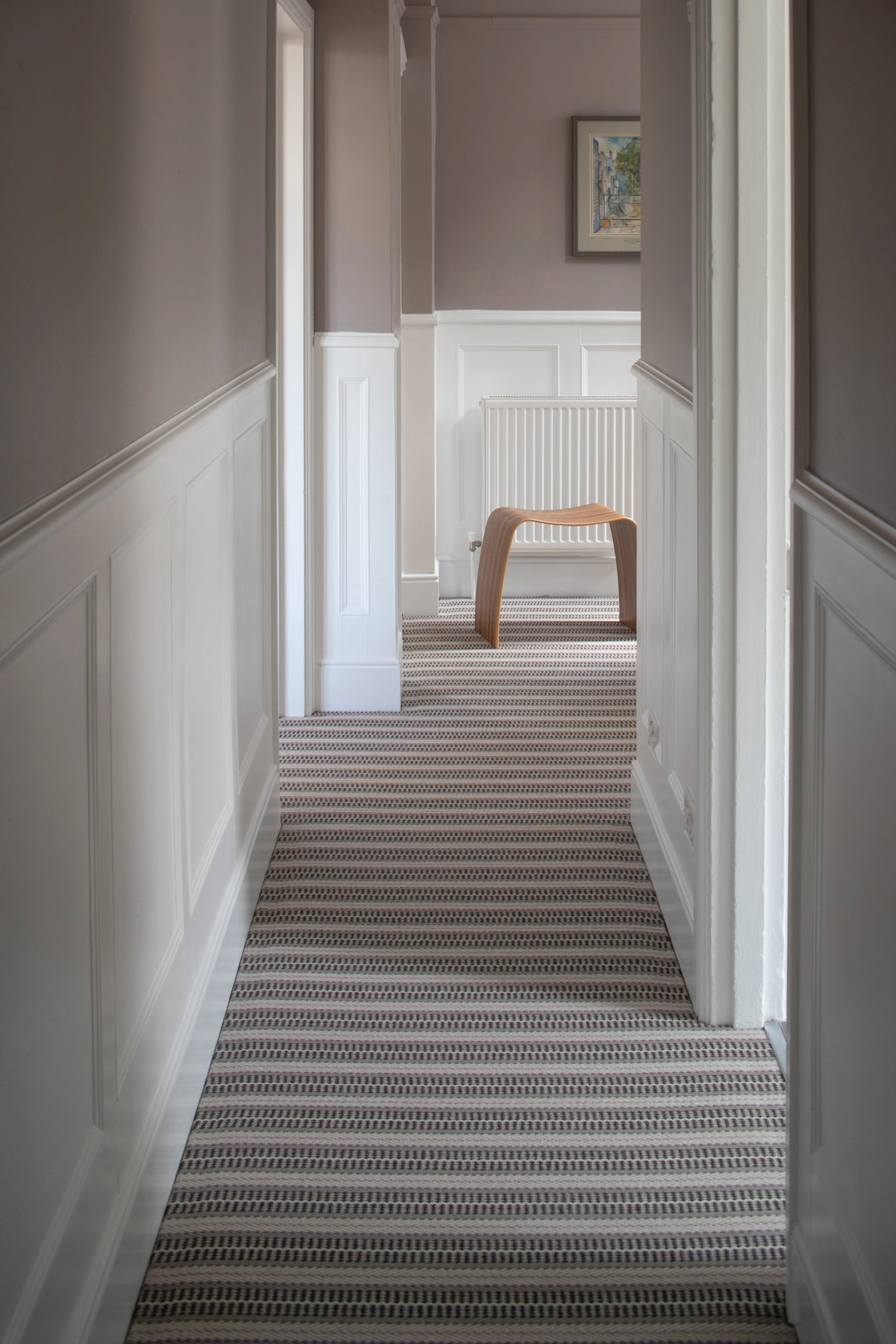 A beige striped carpet in a hallway